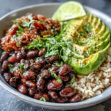 Colorful plant-based taco bowl showcasing seasoned black beans, avocado, and zesty homemade salsa.