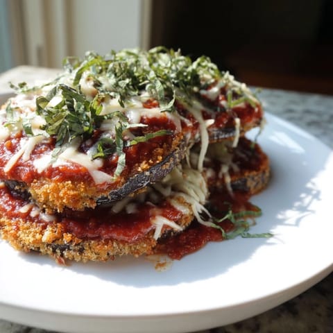 A close-up of a bubbling Eggplant Parmesan, showcasing a hearty, baked Italian main course.
