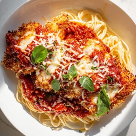 Oven-baked Chicken Parmesan with melted mozzarella, a classic Italian-American comfort food dinner.